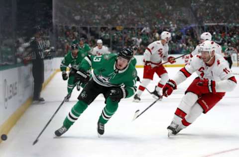 DALLAS, TEXAS – FEBRUARY 11: Mattias Janmark #13 of the Dallas Stars skates the puck against Jordan Staal #11 of the Carolina Hurricanes in the first period at American Airlines Center on February 11, 2020 in Dallas, Texas. (Photo by Ronald Martinez/Getty Images)