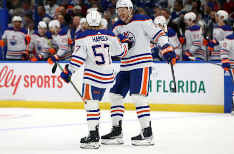 Nov 18, 2023; Tampa, Florida, USA; Edmonton Oilers left wing James Hamblin (57) is congratulated by Edmonton Oilers defenseman Vincent Desharnais (73) after he scored a goal against the Tampa Bay Lightning during the first period at Amalie Arena. Mandatory Credit: Kim Klement Neitzel-USA TODAY Sports