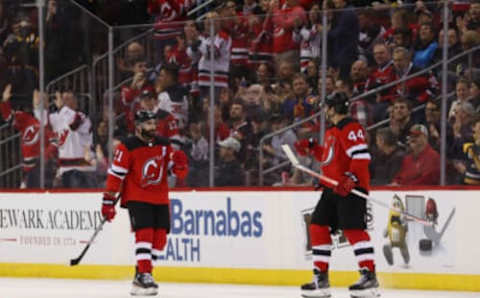 Mar 10, 2020; Newark, New Jersey, USA; New Jersey Devils left wing Miles Wood (44) celebrates his goal with New Jersey Devils right wing Kyle Palmieri (21) during the third period of their game against the Pittsburgh Penguins at Prudential Center. Mandatory Credit: Ed Mulholland-USA TODAY Sports