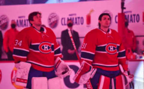 MONTREAL, QC – JANUARY 28: Goaltenders Jake Allen #34 (L) and Carey Price #31 of the Montreal Canadiens (R) look on during the pre-game ceremony prior to the home opening game against the Calgary Flames at the Bell Centre on January 28, 2021 in Montreal, Canada. The Montreal Canadiens defeated the Calgary Flames 4-2. (Photo by Minas Panagiotakis/Getty Images)