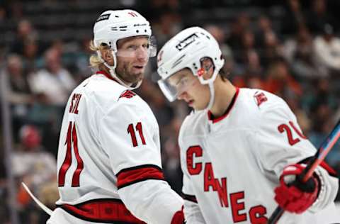 ANAHEIM, CALIFORNIA – NOVEMBER 18: Jordan Staal #11 talks with Sebastian Aho #20 of the Carolina Hurricanes during the third period of a game against the Anaheim Ducks at Honda Center on November 18, 2021, in Anaheim, California. (Photo by Sean M. Haffey/Getty Images)