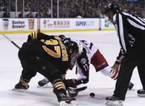 Jan 23, 2016; Boston, MA, USA; Boston Bruins center Patrice Bergeron (37) and Columbus Blue Jackets center Brandon Dubinsky (17) face-off during overtime at TD Garden. Mandatory Credit: Bob DeChiara-USA TODAY Sports