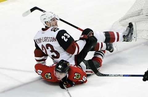 Apr 5, 2016; Chicago, IL, USA; Arizona Coyotes defenseman Oliver Ekman-Larsson (23) lands on Chicago Blackhawks left wing Teuvo Teravainen (86) in the third period at the United Center. Mandatory Credit: Matt Marton-USA TODAY Sports