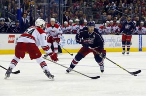 Jan 9, 2016; Columbus, OH, USA; Columbus Blue Jackets center Boone Jenner (38) carries the puck as Carolina Hurricanes defenseman Brett Pesce (54) defends during the second period at Nationwide Arena. Mandatory Credit: Russell LaBounty-USA TODAY Sports