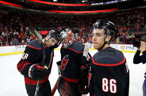 RALEIGH, NC – FEBRUARY 01: Petr Mrazek #34 of the Carolina Hurricanes is congratulated by teammates Teuvo Teravainen #86 and Jordan Martinook #48 after defeating the Vegas Golden Knights during an NHL game on February 1, 2019 at PNC Arena in Raleigh, North Carolina. (Photo by Gregg Forwerck/NHLI via Getty Images)