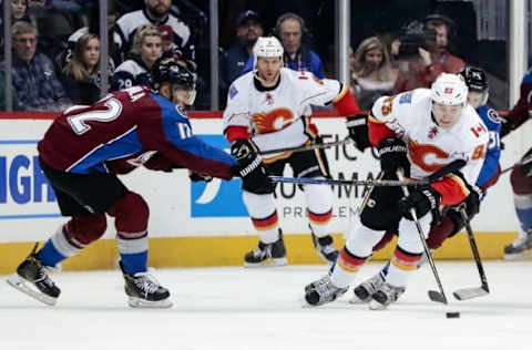 Dec 27, 2016; Denver, CO, USA; Calgary Flames center Sam Bennett (93) controls the puck as Colorado Avalanche right wing Jarome Iginla (12) defends in the first period at the Pepsi Center. Mandatory Credit: Isaiah J. Downing-USA TODAY Sports