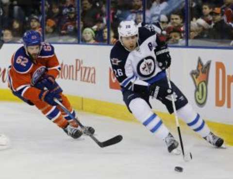 Dec 21, 2015; Edmonton, Alberta, CAN; Winnipeg Jets forward Blake Wheeler (26) skates with the puck against the Edmonton Oilers during the first period at Rexall Place. Mandatory Credit: Perry Nelson-USA TODAY Sports