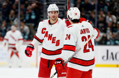 SEATTLE, WASHINGTON – NOVEMBER 24: Brendan Smith #7 of the Carolina Hurricanes celebrates his goal against the Seattle Kraken with Seth Jarvis #24 during the first period at Climate Pledge Arena on November 24, 2021, in Seattle, Washington. (Photo by Steph Chambers/Getty Images)