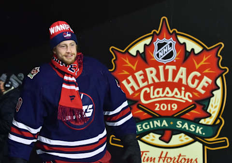 REGINA, SK – OCTOBER 26: Laurent Brossoit #30 of the Winnipeg Jets walks to the ice to start the third period against the Calgary Flames during the 2019 Tim Hortons NHL Heritage Classic at Mosaic Stadium on October 26, 2019 in Regina, Saskatchewan, Canada. (Photo by Minas Panagiotakis/NHLI via Getty Images)