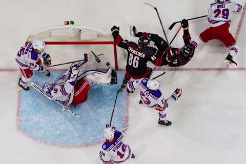 Jan 21, 2022; Raleigh, North Carolina, USA; Carolina Hurricanes center Sebastian Aho (20) scores a goal past New York Rangers goaltender Alexandar Georgiev (40) during the second period at PNC Arena. Mandatory Credit: James Guillory-USA TODAY Sports