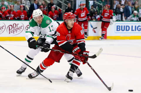 DALLAS, TX – FEBRUARY 23: Carolina Hurricanes left wing Teuvo Teravainen (86) reaches for a puck with Dallas Stars center Mattias Janmark (13) defending during the game between the Carolina Hurricanes and the Dallas Stars on February 23, 2019 at American Airlines Center in Dallas, TX. (Photo by Andrew Dieb/Icon Sportswire via Getty Images)