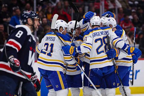 WASHINGTON, DC – MARCH 15: Ilya Lyubushkin #46 of the Buffalo Sabres celebrates with teammates after scoring a goal as Alex Ovechkin #8 of the Washington Capitals looks on during the first period of the game at Capital One Arena on March 15, 2023 in Washington, DC. (Photo by Scott Taetsch/Getty Images)