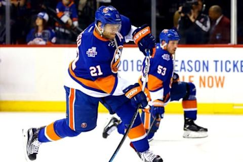 Apr 20, 2016; Brooklyn, NY, USA; New York Islanders right wing Kyle Okposo (21) shoots the puck during warmups prior to game four of the first round of the 2016 Stanley Cup Playoffs against the Florida Panthers at Barclays Center. Mandatory Credit: Andy Marlin-USA TODAY Sports