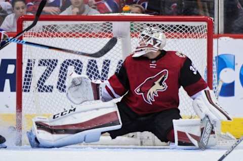 Feb 15, 2016; Glendale, AZ, USA; Arizona Coyotes goalie Louis Domingue (35) makes a save during the second period against the Montreal Canadiens at Gila River Arena. Mandatory Credit: Matt Kartozian-USA TODAY Sports