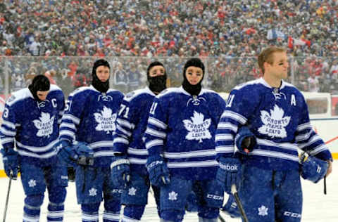 TORONTO , ON – JANUARY 1: The Toronto Maple Leafs stand for the singing of the national anthem before action against the Detroit Red Wings during NHL game action during the 2014 Bridgestone NHL Winter Classic January 1, 2014 at Michigan Stadium in Ann Arbor, Michigan. (Photo by Graig Abel/NHLI via Getty Images)