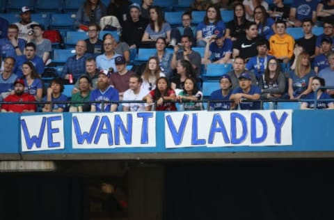 TORONTO, ON – MAY 23: Toronto Blue Jays fans hang a sign calling for Vladimir Guerrero Jr. to be brought up to the big league club during MLB game action against the Los Angeles Angels of Anaheim at Rogers Centre on May 23, 2018 in Toronto, Canada. (Photo by Tom Szczerbowski/Getty Images) *** Local Caption *** Vladimir Guerrero Jr.