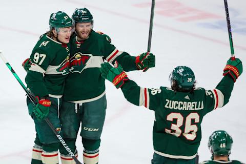 Mats Zuccarello celebrates a goal with linemates Kirill Kaprizov and Ryan Hartman. (Matt Krohn-USA TODAY Sports)