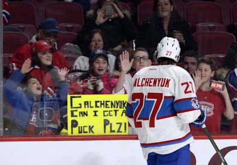 Jan 19, 2016; Montreal, Quebec, CAN; Montreal Canadiens forward Alex Galchenyuk (27) gives a puck to a fan during the warmup period before the game against the Boston Bruins at the Bell Centre. Mandatory Credit: Eric Bolte-USA TODAY Sports