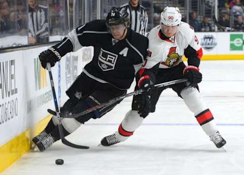 Jan 16, 2016; Los Angeles, CA, USA; Los Angeles Kings center Anze Kopitar (11) and Ottawa Senators right wing Alex Chiasson (90) battle on the boards in the second period of the game at Staples Center. Mandatory Credit: Jayne Kamin-Oncea-USA TODAY Sports