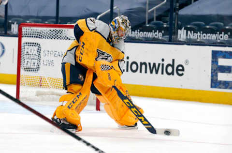 Feb 18, 2021; Columbus, Ohio, USA; Nashville Predators goalie Juuse Saros (74) clears the puck against the Columbus Blue Jackets during the third period at Nationwide Arena. Mandatory Credit: Russell LaBounty-USA TODAY Sports