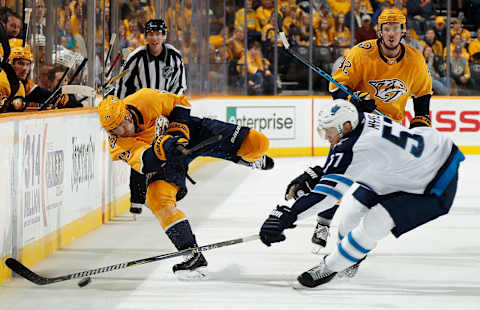 NASHVILLE, TN – OCTOBER 11: Craig Smith #15 of the Nashville Predators dumps the puck in the zone against Tyler Myers #57 of the Winnipeg Jets at Bridgestone Arena on October 11, 2018 in Nashville, Tennessee. (Photo by John Russell/NHLI via Getty Images)