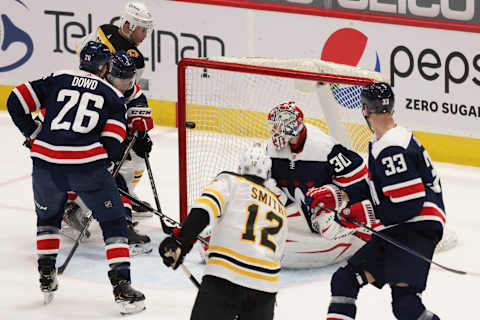 Apr 8, 2021; Washington, District of Columbia, USA; Boston Bruins center Craig Smith (12) scores a goal on Washington Capitals goaltender Ilya Samsonov (30) in the third period at Capital One Arena. Mandatory Credit: Geoff Burke-USA TODAY Sports