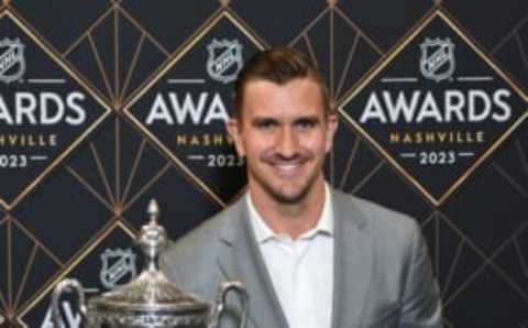 Jun 26, 2023; Nashville, Tennessee, USA; Calgary Flames center Mikael Backlund poses with the King Clancy Memorial Trophy after winning it during the 2023 NHL Awards at Bridgestone Arena. Mandatory Credit: Christopher Hanewinckel-USA TODAY Sports