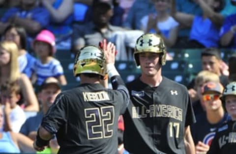 Aug 15, 2015; Chicago, IL, USA; American team Carter Kieboom (22) is greeted by Joey Weentz (17) after scoring a run against the National team during the first inning in the Under Armour All America Baseball game at Wrigley field. Mandatory Credit: David Banks-USA TODAY Sports