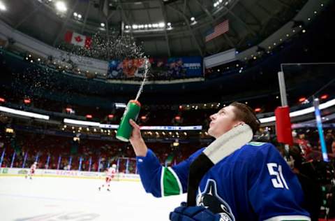 VANCOUVER, BC – OCTOBER 15: Troy Stecher #51 of the Vancouver Canucks sprays water in the air during their NHL game against the Detroit Red Wings at Rogers Arena October 15, 2019 in Vancouver, British Columbia, Canada. (Photo by Jeff Vinnick/NHLI via Getty Images)”n