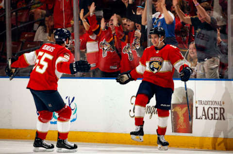 SUNRISE, FL – NOVEMBER 3: One of Denis Malgin’s (right) 6 rookie goals came against New Jersey on home ice; celebrates with fans and Jason Demers (left)