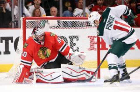 May 1, 2015; Chicago, IL, USA; Minnesota Wild left wing Zach Parise (11) scores a goal past Chicago Blackhawks goalie Corey Crawford (50) during the second period in game one of the second round of the 2015 Stanley Cup Playoffs at United Center. Mandatory Credit: Jerry Lai-USA TODAY Sports