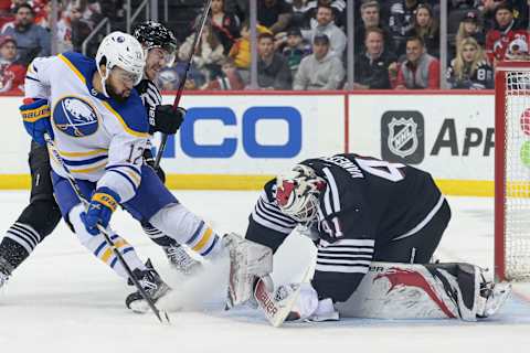 Apr 11, 2023; Newark, New Jersey, USA; New Jersey Devils goaltender Vitek Vanecek (41) covers the puck as Buffalo Sabres left wing Jordan Greenway (12) battles New Jersey Devils right wing Nathan Bastian (14) during the second period at Prudential Center. Mandatory Credit: Vincent Carchietta-USA TODAY Sports