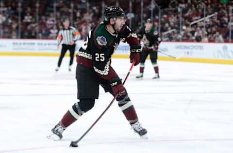 Oct 23, 2021; Glendale, Arizona, USA; Arizona Coyotes defenseman Conor Timmins (25) shoots the puck against the New York Islanders during the second period at Gila River Arena. Mandatory Credit: Joe Camporeale-USA TODAY Sports