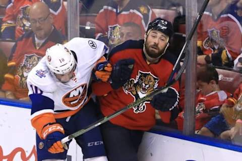 Apr 22, 2016; Sunrise, FL, USA; New York Islanders center Alan Quine (10) checks Florida Panthers defenseman Erik Gudbranson (44) in the second overtime of game five of the first round of the 2016 Stanley Cup Playoffs at BB&T Center. The Islanders won 2-1. Mandatory Credit: Robert Mayer-USA TODAY Sports