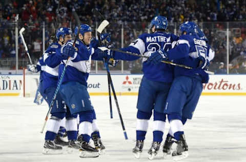 Jan 1, 2017; Toronto, Ontario, CAN; Toronto Maple Leafs players embrace forward Auston Matthews (34) after he scored the overtime winning goal in a 5-4 win over Detroit Red Wings in the Centennial Classic ice hockey game at BMO Field. Mandatory Credit: Dan Hamilton-USA TODAY Sports