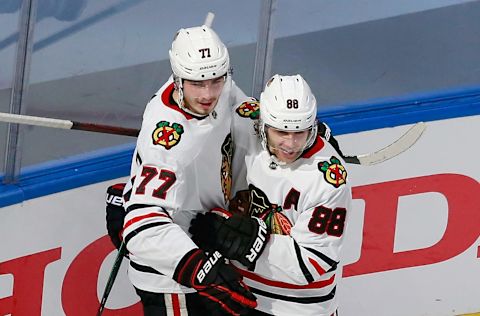 Kirby Dach #77 of the Chicago Blackhawks (L) celebrates his goal at 3:17 of the second period against the Vegas Golden Knights and is joined by Patrick Kane #88 (R) in Game Two of the Western Conference First Round. (Photo by Jeff Vinnick/Getty Images)