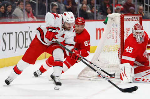 Mar 10, 2020; Detroit, Michigan, USA; Carolina Hurricanes left wing Jordan Martinook (48) shoots against Detroit Red Wings goaltender Jonathan Bernier (45) and defenseman Trevor Daley (83) during the first period at Little Caesars Arena. Mandatory Credit: Raj Mehta-USA TODAY Sports