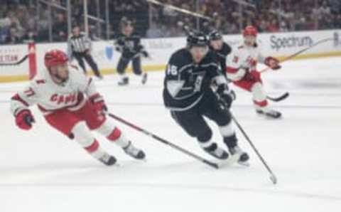 Oct 14, 2023; Los Angeles, California, USA; Los Angeles Kings Center Blake Lizotte (46) makes a play against Carolina Hurricanes Defensemen Tony DeAngelo (77) during the second period at Crypto.com Arena. Mandatory Credit: Yannick Peterhans-USA TODAY Sports