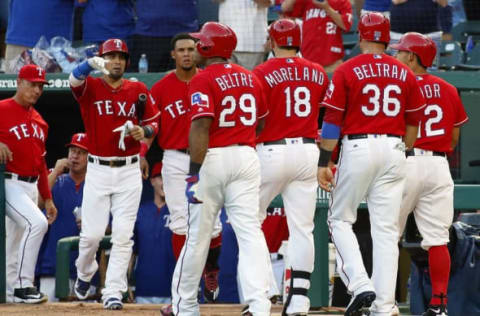 Aug 27, 2016; Arlington, TX, USA; Texas Rangers third baseman Adrian Beltre (29) and first baseman Mitch Moreland (18) and right fielder Carlos Beltran (36) and second baseman Rougned Odor (12) are greeted at the dugout after scoring on a first inning grand slam by Moreland against the Cleveland Indians at Globe Life Park in Arlington. The Rangers won 7-0. Mandatory Credit: Ray Carlin-USA TODAY Sports