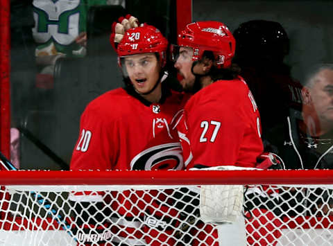 RALEIGH, NC – DECEMBER 23: Justin Faulk #27 of the Carolina Hurricanes celebrates his second period goal against the Buffalo Sabres with teammate Sebastian Aho #20 during an NHL game on December 23, 2017 at PNC Arena in Raleigh, North Carolina. (Photo by Gregg Forwerck/NHLI via Getty Images)