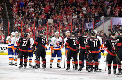 RALEIGH, NORTH CAROLINA – MAY 03: The Carolina Hurricanes and the New York Islanders shake hands after Game Four of the Eastern Conference Second Round during the 2019 NHL Stanley Cup Playoffs at PNC Arena on May 03, 2019 in Raleigh, North Carolina. The Hurricanes won 5-2 and won the series, 4-0. (Photo by Grant Halverson/Getty Images)