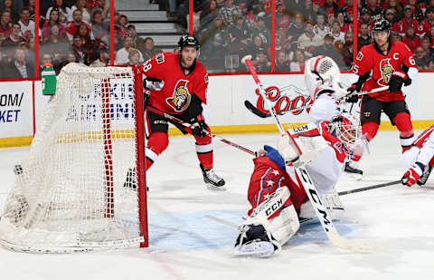 OTTAWA, ON – APRIL 4: The puck gets past Braden Holtby #70 of the Washington Capitals on a power-play goal in the first period as Mike Hoffman #68 and Erik Karlsson #65 of the Ottawa Senators look on at Canadian Tire Centre on April 4, 2015 in Ottawa, Ontario, Canada. (Photo by Jana Chytilova/NHLI via Getty Images)