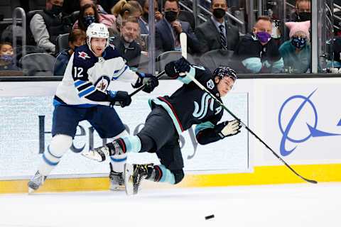 Jansen Harkins #12, Winnipeg Jets; Yanni Gourde #37, Seattle Kraken. (Photo by Steph Chambers/Getty Images)