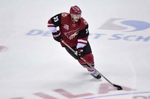 Nov 23, 2016; Glendale, AZ, USA; Arizona Coyotes defenseman Alex Goligoski (33) carries the puck during the first period against the Vancouver Canucks at Gila River Arena. Mandatory Credit: Matt Kartozian-USA TODAY Sports