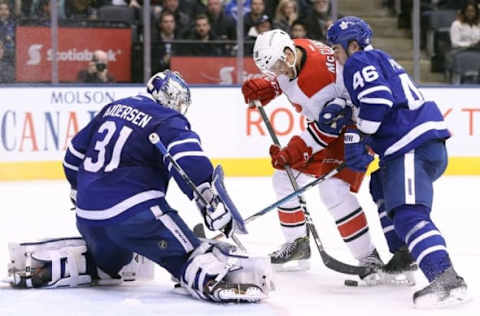 Nov 22, 2016; Toronto, Ontario, CAN; Carolina Hurricanes center Jay McClement (18) battles for a loose puck in front of the net as Toronto Maple Leafs defenseman Roman Polak (46) checks him and goalie Frederik Andersen (31) guards the net at Air Canada Centre. The Hurricanes beat the Maple Leafs 2-1. Mandatory Credit: Tom Szczerbowski-USA TODAY Sports