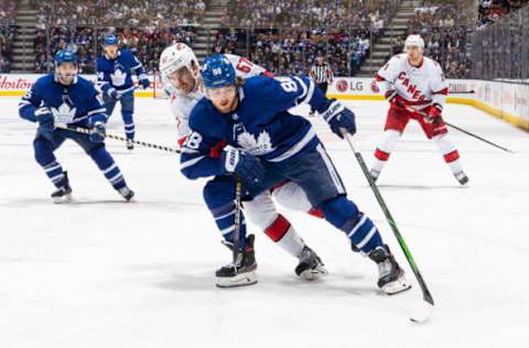 William Nylander #88 of the Toronto Maple Leafs plays the puck against Trevor van Riemsdyk #57 of the Carolina Hurricanes  (Photo by Mark Blinch/NHLI via Getty Images)