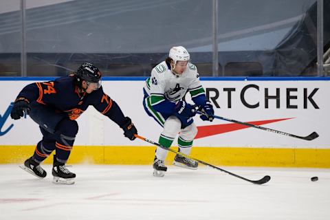 EDMONTON, AB – MAY 15: Ethan Bear #74 of the Edmonton Oilers battles for the puck against Quinn Hughes #43 of the Vancouver Canucks at Rogers Place on May 15, 2021 in Edmonton, Canada. (Photo by Codie McLachlan/Getty Images)