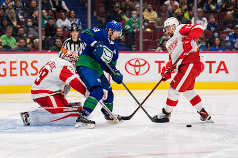 Mar 17, 2022; Vancouver, British Columbia, CAN; Detroit Red Wings goalie Alex Nedeljkovic (39) looks on as Vancouver Canucks forward J.T. Miller (9) battles with defenseman Filip Hronek (17) in the third period at Rogers Arena. Detroit won 1-0. Mandatory Credit: Bob Frid-USA TODAY Sports