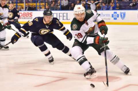 Feb 6, 2016; St. Louis, MO, USA; Minnesota Wild defenseman Nate Prosser (39) controls the puck away from St. Louis Blues center Paul Stastny (26) during the second period at Scottrade Center. Mandatory Credit: Jasen Vinlove-USA TODAY Sports