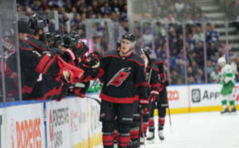 Mar 17, 2023; Toronto, Ontario, CAN; Carolina Hurricanes defenseman Brady Skjei (76) celebrates at the bench after scoring a goal during the first period against the Toronto Maple Leafs at Scotiabank Arena. Mandatory Credit: Nick Turchiaro-USA TODAY Sports